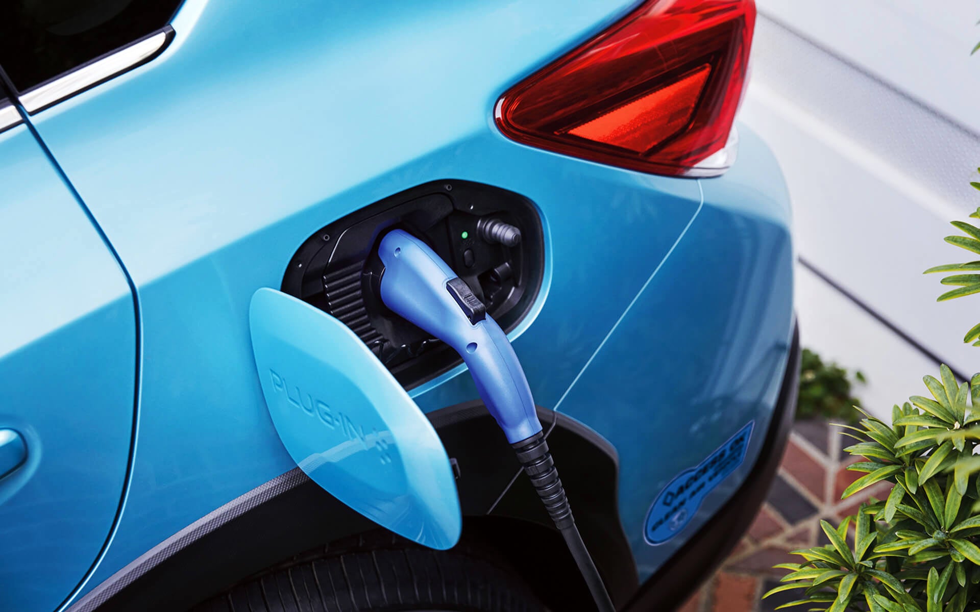 A close-up of the Subaru Crosstrek Hybrid's charging port with charging cable plugged in | Zappone Subaru Norwich in Norwich NY
