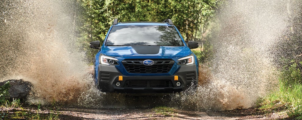 A 2023 Outback Wilderness driving on a muddy trail. | Zappone Subaru Norwich in Norwich NY