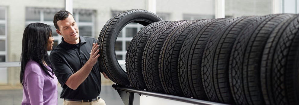Subaru service representative showing customer a tire. | Zappone Subaru Norwich in Norwich NY